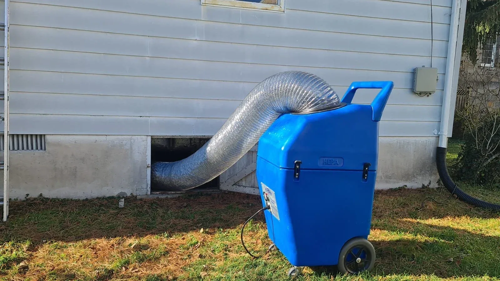 HEPA-certified commercial-grade air duct cleaning machine connected to a home