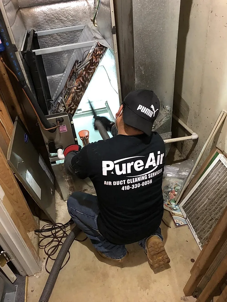 Pure Air technician cleaning a furnace